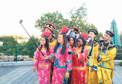 北京景山公園で中国の古代皇宮の衣装を着て写真を撮影する外国人ら。（撮影：高炳）
