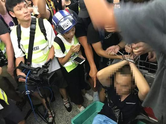 香港空港のデモ隊、中国大陸部の記者に暴行