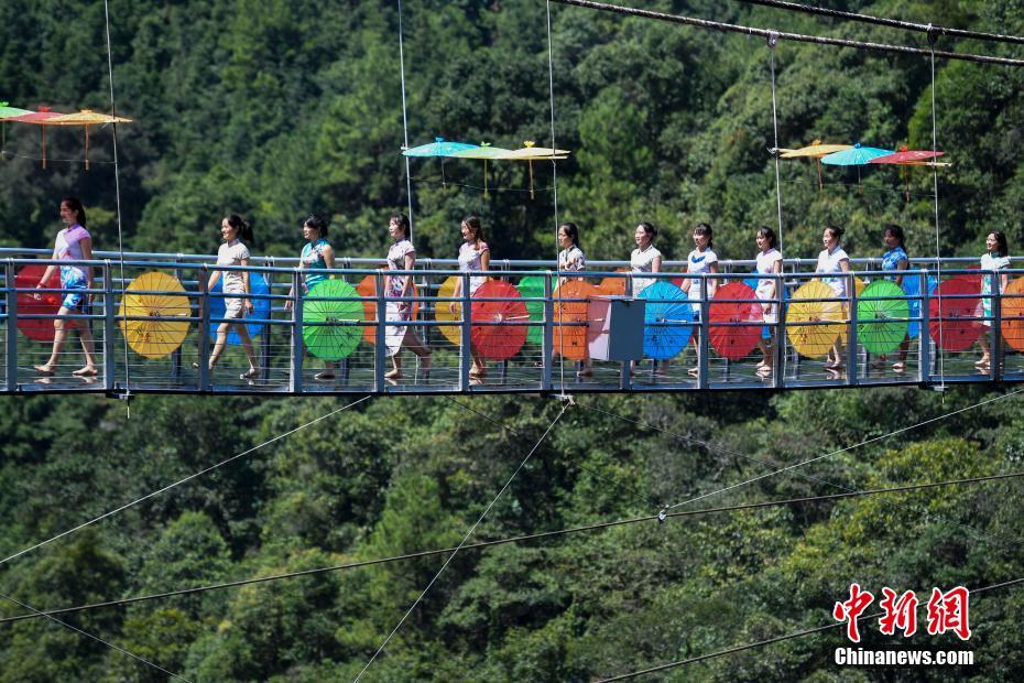 天空の橋でカラフルな傘とチャイナドレスのショー　湖南省九竜江