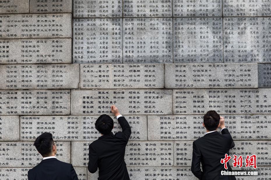 中国侵略日本軍南京大虐殺の犠牲者名が刻まれた壁で、犠牲者の名前を一つ一つ「書き直し」ていく南京審計大学のボランティア（撮影・泱波）。 