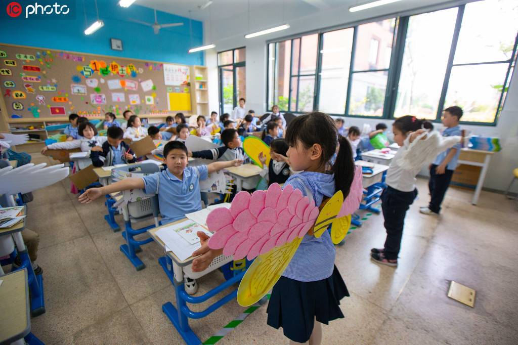 「1メートル幅の翼」を背に登校する可愛い小学生たち　浙江省杭州市