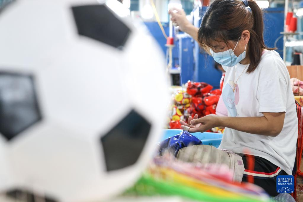貴州省遵義市務川コーラオ族ミャオ族自治県のメーカーで、サッカーボールを縫製する作業員（6月15日撮影・欧東衢）。