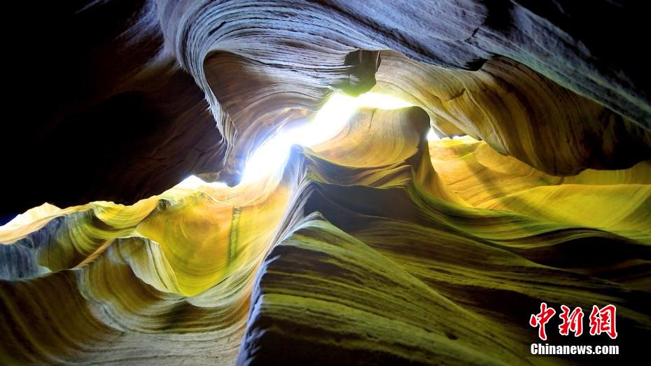 甘泉大峡谷で、波模様の石壁に差し込む太陽光（撮影・白騰）。