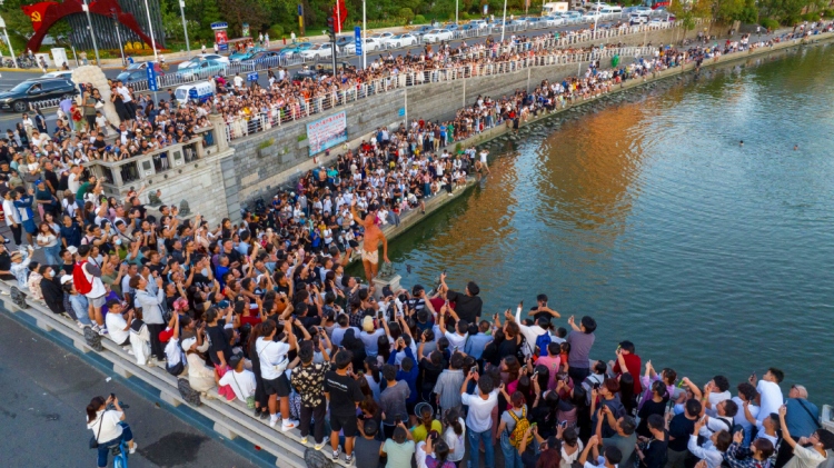 2023年8月28日、天津市の獅子林橋で、飛び込み愛好者の周りに大勢の人が集まる様子。（撮影・王慶/写真提供は視覚中国）