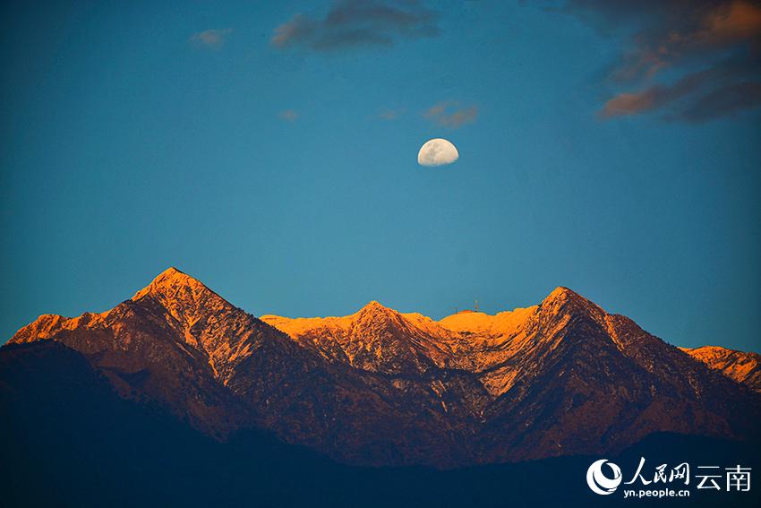 夕日に照らされた大理蒼山と空に浮かぶ月を楽しむ　雲南省
