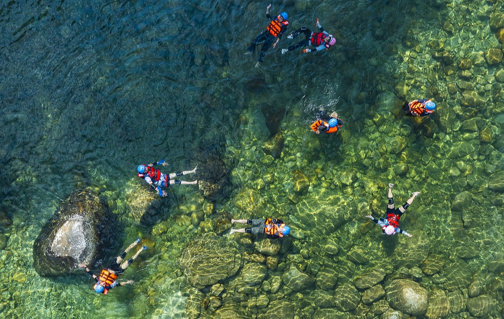7月30日、広西壮（チワン）族自治区桂林市興安県猫児山景勝地で、流れがゆったりした川に浮かぶアクティビティを体験する観光客（写真著作権はCFP視覚中国所有のため転載禁止）。
