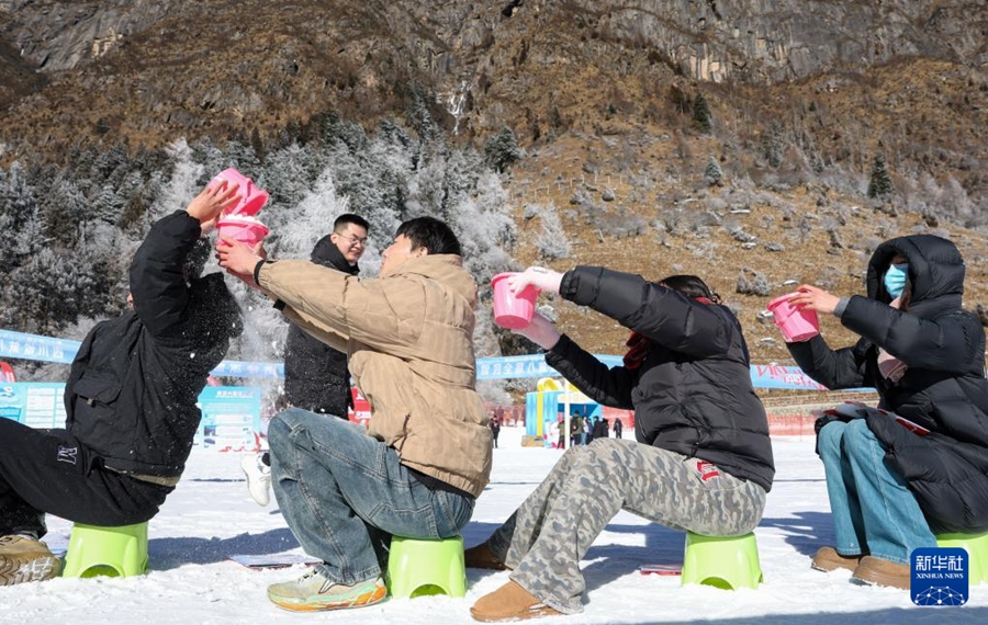 畢棚溝スキー場で、「雪のバケツリレー」ゲームを楽しむ観光客（1月5日撮影・江宏景）。