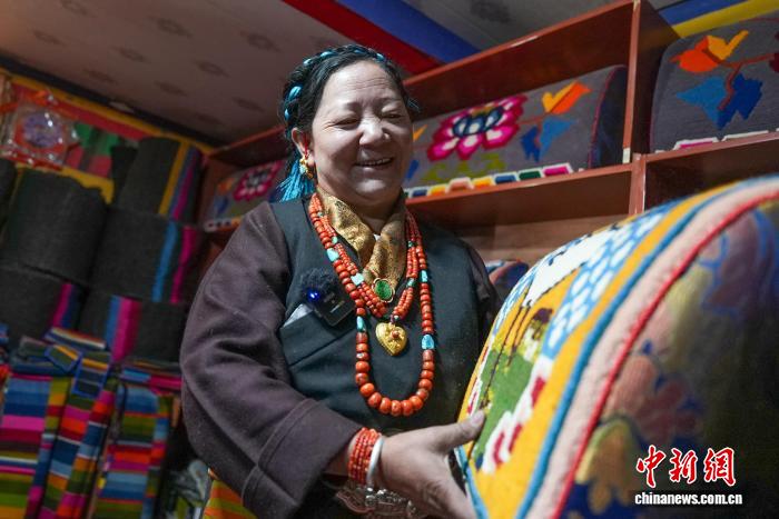 製品を見せる徳吉さん（撮影・貢確）。