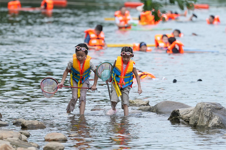 安吉県孝源街道（エリア）を流れる川で魚捕りを楽しむ子供たち（2026年8月6日撮影・黄宗治）。