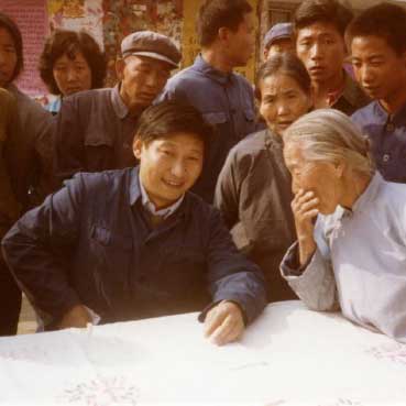 習近平総書記写真集1983年、河北正定県委員会書記をつとめる習氏（前列中央）、街角で民衆の意見を聞く