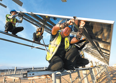 庫布其砂漠新エネルギー拠点で、ソーラーパネルの設置作業を行う作業員。